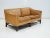 Two-seater caramel brown leather sofa designed in Denmark and manufactured by Grant in circa 1970/80s. Stained wood base...