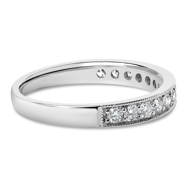 Imbued with timeless elegance, this 14k white gold wedding band gracefully celebrates matrimonial joy. Pave set across its...