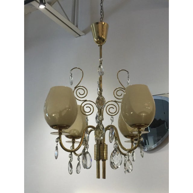 This 4-light chandelier by Almari Mauri of Finland, in brass, glass and faceted crystals. Beautiful vintage piece with a...