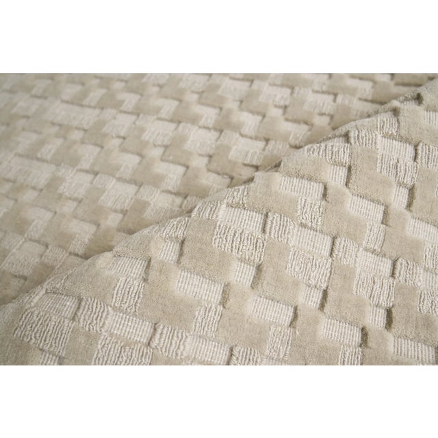 The versatility of a solid color rug with a little more intrigue. A mix of high and low geometric shapes gives the Monroe...