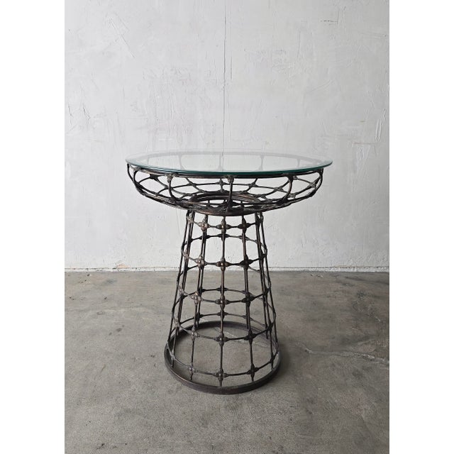 This lightweight metal pedestal table os visually stunning. I love the sculptural lattice base and repeating rosette...