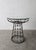 This lightweight metal pedestal table os visually stunning. I love the sculptural lattice base and repeating rosette...