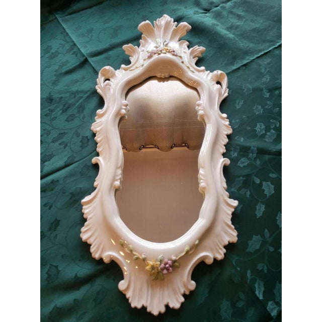 Large mirror, La Farnesiana of Parma, designed by Carlo Corvi, made of white majolica ceramic, decorated with delicate...