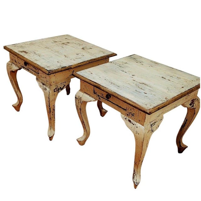 These tables are identified as French Provincial side tables with a distressed cream finish. They are from the Mid-20th...