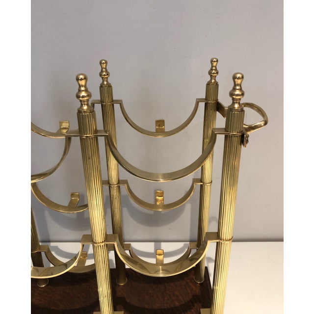 This beautiful neoclassical style bottle rack is made of brass on a wooden base. It is a French work in the style of...