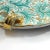 A beautiful patera made of glazed majolica kept in a Renaissance style. Hand -decorated and gilded. Slight iridescent...
