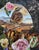 In "A Haunting Melody," a wren perches gracefully amidst a lush arrangement of roses and tulips, creating a striking focal...