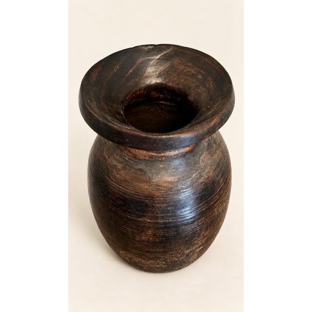 A striking vintage wooden vessel believed to be of Himalayan origin, possibly from Nepal or Northern India. Traditionally...