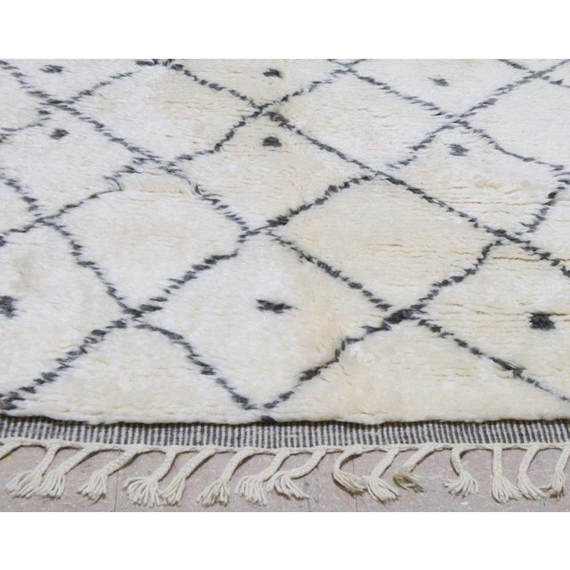 Hand-knotted with care using traditional rug making techniques, this wool rug blends timeless craftsmanship with a modern...