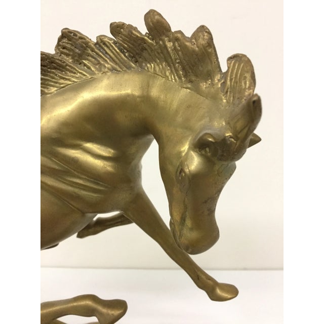 A gorgeous stallion is bucking like crazy wanting to be free. This work of art is vintage and in wonderful condition....