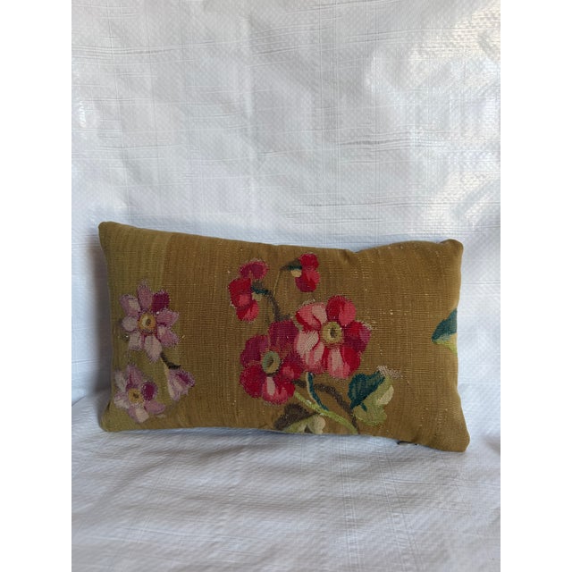 This beautiful antique lumbar pillow is fashioned from a historic French Aubusson-style tapestry fragment featuring an...