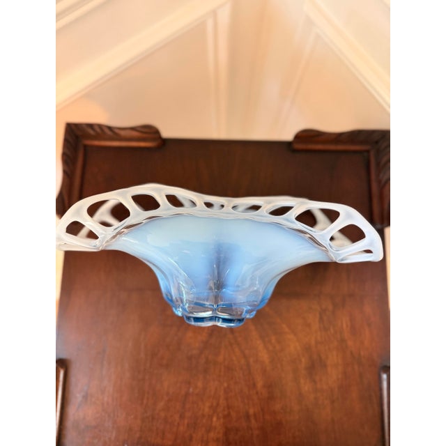 Sculptural vintage hand blown art glass centerpiece bowl featuring a dramatic pierced openwork rim surrounding a soft blue...