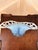 Sculptural vintage hand blown art glass centerpiece bowl featuring a dramatic pierced openwork rim surrounding a soft blue...