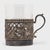 This 20th century European silver cup holder, set with a glass tumbler, boasts an exquisitely detailed filigree mount and...