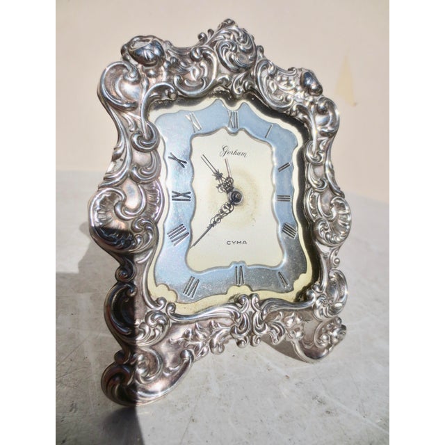 Baroque-style CYMA table Alarm clock ( working), with daily wind-up. Sterling face and silver-plated back of case. Working...