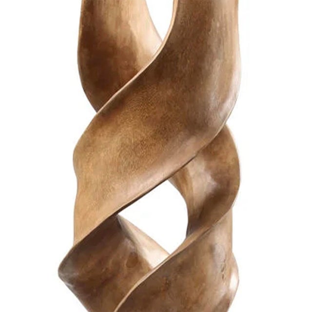 This teak wood sculpture features an organic, twisting form with sweeping curves and sculptural openings that beautifully...