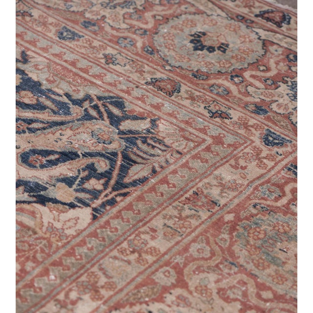 This 1900's Antique Persian Tabriz rug is a refined example of early 20th-century Persian craftsmanship, distinguished by...