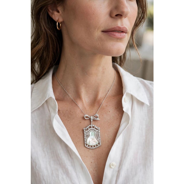 Vintage Art Deco 18k white gold pendant brooch featuring a finely hand-carved mother-of-pearl depiction of the Virgin...
