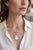 Vintage Art Deco 18k white gold pendant brooch featuring a finely hand-carved mother-of-pearl depiction of the Virgin...
