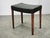 Elegant Danish Modern stool from the 1960s, crafted in Denmark from wood and black leather. The stool embodies the...