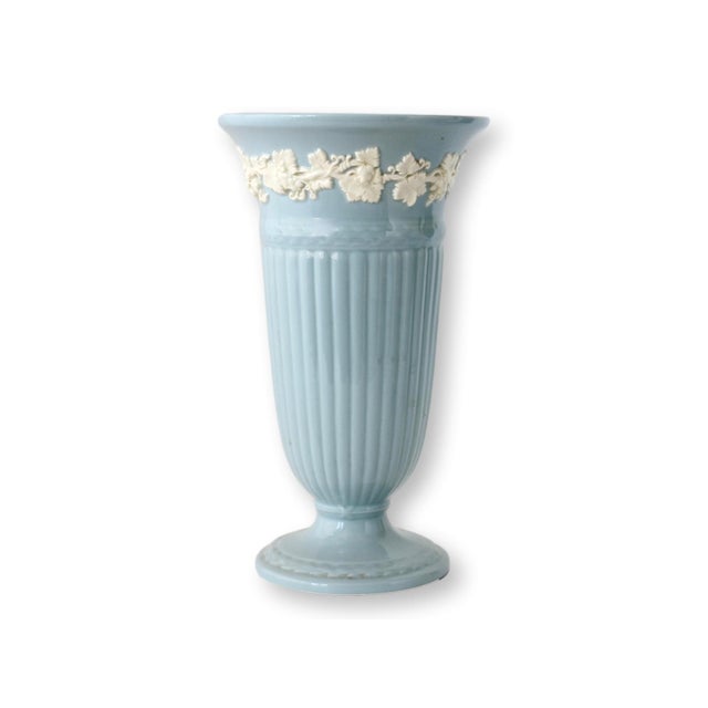 Beautiful pair of Wedgwood Queensware vases in the classic cream on Wedgwood blue colorway. These pieces feature a refined...