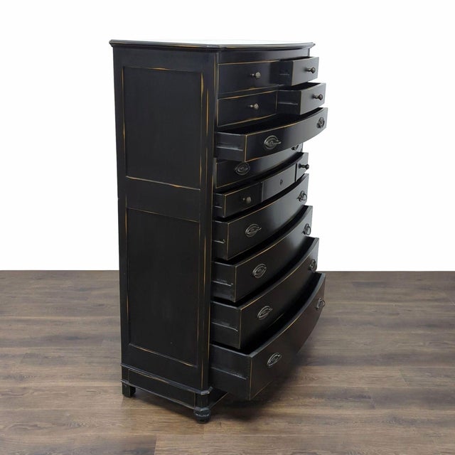 This black dresser features a distressed finish for a stylish, vintage look. It comes with eleven spacious drawers,...