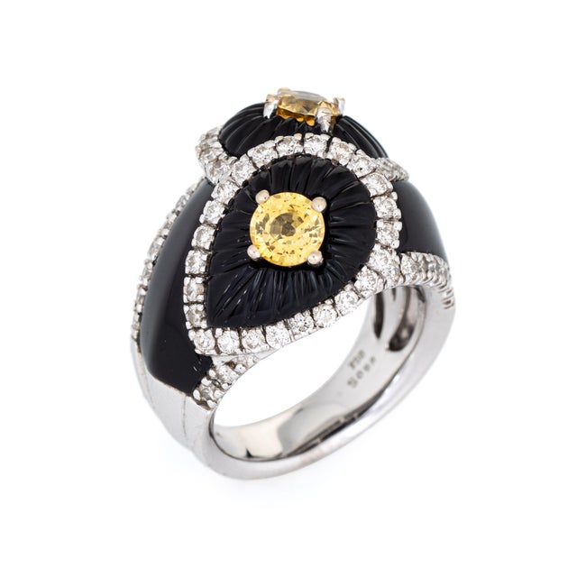 Stylish fluted onyx, yellow sapphire & diamond cocktail ring crafted in 18 karat white gold. Two faceted round cut yellow...