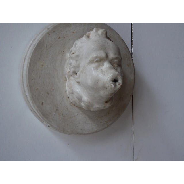 Decorative plaster wall sculpture of a Triton fountain head, the plaster well polished, hangs on a single screw or nail.
