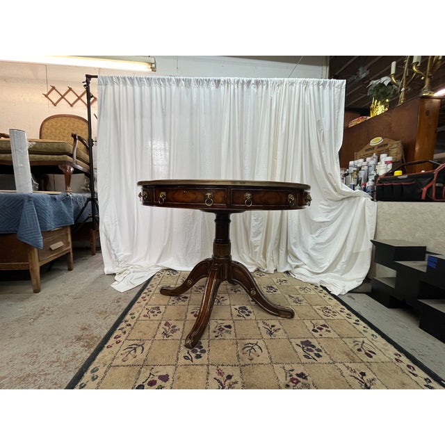 An extraordinary masterpiece of artisan craftsmanship, this Regency-style circular center or breakfast table is...