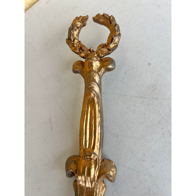 Vintage wall mount plate holder with acanthus laurel peace wreaths at the top and intricate scrollwork detail in an...