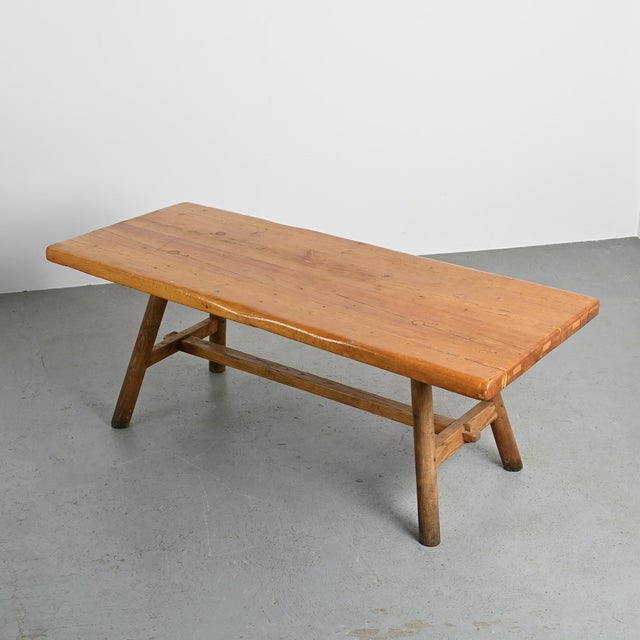 Large dining table by Christian Durupt, made of solid wood in the early 1960s. The rectangular tabletop, composed of wide...