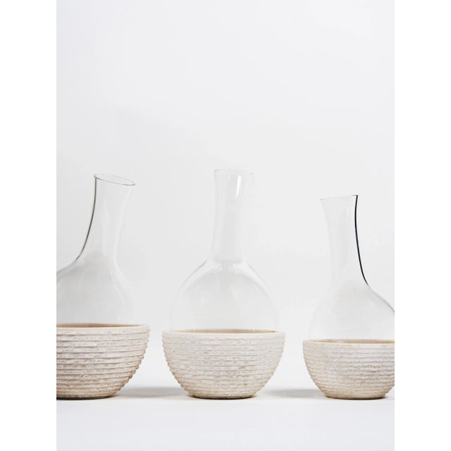 The bottles collection, made of crystal and placed on levigated bowls, symbolises the small drop that can dig the hard...