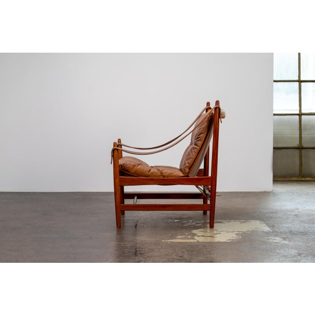 Scandinavian Mid-Century Safari Chair made of teak and brown leather This elegant Safari Chair is an iconic example of the...