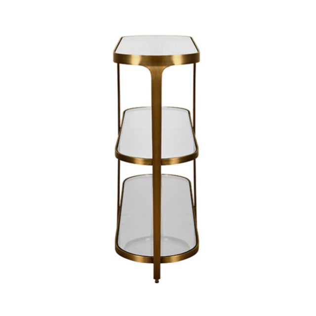 New special order item. Not vintage. Elevate your entryway with this striking three-tier glass top racetrack console....