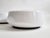 A minimalist white opaline glass flush mount ceiling or wall light, Austria, 1960s–1970s. The shallow domed glass shade is...