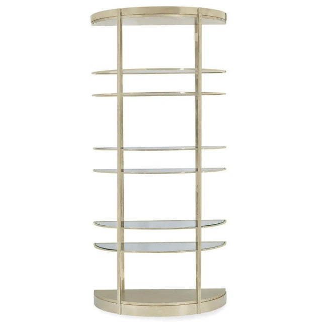 An etagere with a light and airy design. The tall frame has been given a high polished gold finish and surrounds each of...
