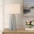 The Cover Up Table Lamp Features A Gracefully Sculpted Ceramic Base, Reminiscent Of Softly Draped Fabric, In Muted Light...