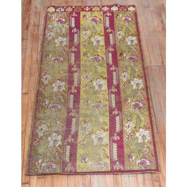 An authentic small late 19th centuryTurkish Ghiordes runner with a floral motif. Measures: 3'6'' x 7'.
