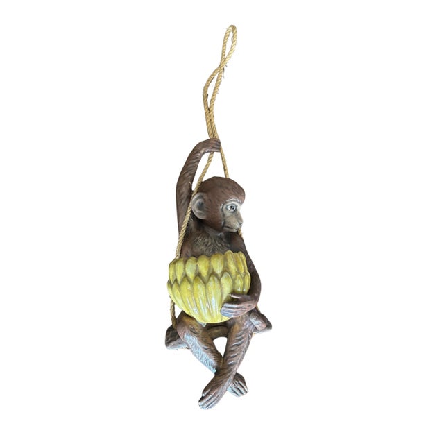 Bring a touch of whimsical tropical charm to your home with this vintage hanging monkey planter from the 1970s. Suspended...