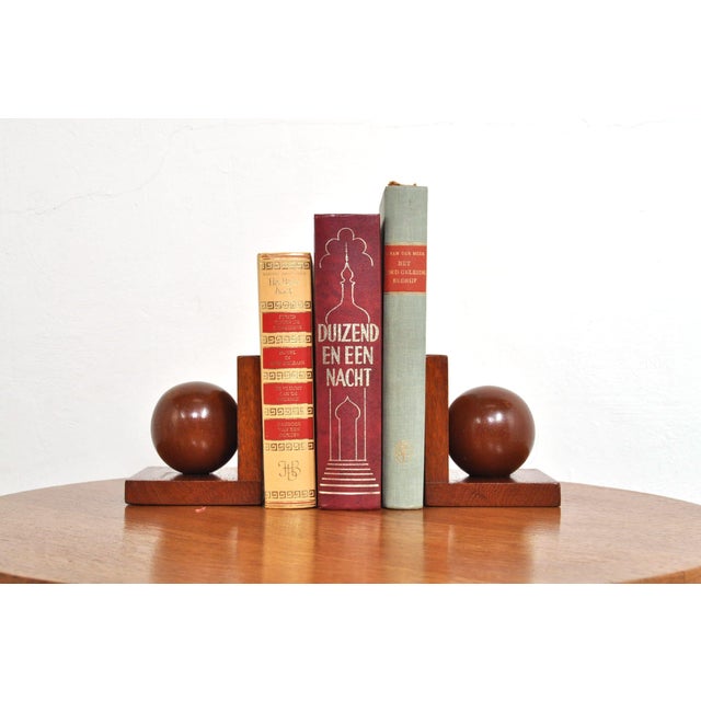 A beautiful pair of art deco / bauhaus bookends. The bookends are made of oak and feature a large wooden ball on top....