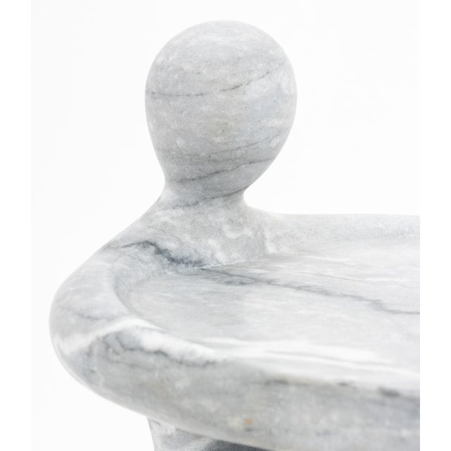 Carved Gray Marble Seated Figure Form Cake Stand. 12" H x 11.5" W x 13.75" D. Provenance: From an East 53rd Street, New...