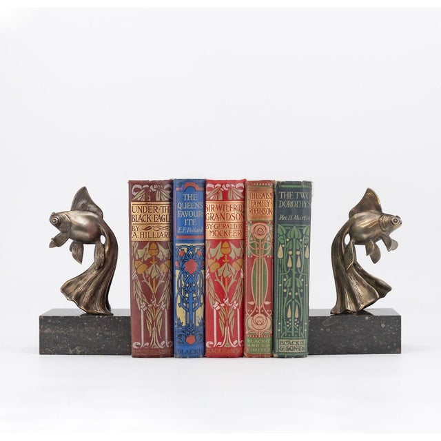 A pair of art deco patinated bronze long-tailed fancy goldfish bookends by georges-raoul garreau, on marble bases. Each...