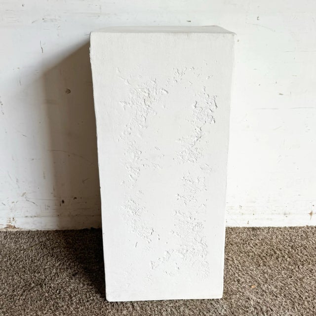 This sleek postmodern white plaster pedestal is a minimalist masterpiece. Its smooth texture is subtly accented with...