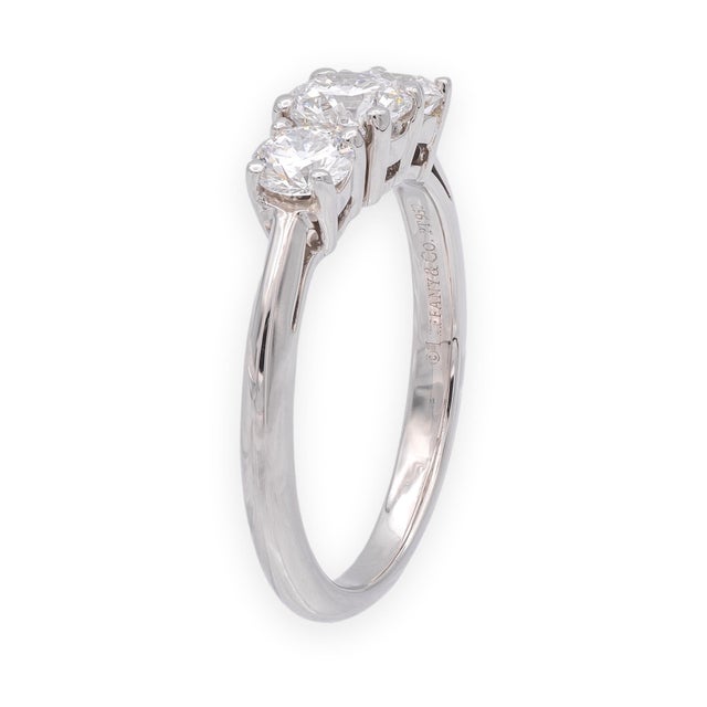 A classic Tiffany & Co. three-stone engagement ring crafted in platinum, set with three round brilliant cut diamonds in an...