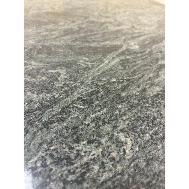 Elegant and substantial, this Green Triple Ogee Marble Double Pedestal Table features a richly veined green marble top...