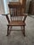 This is a vintage or antique Windsor-style spindle-back rocking chair, structurally identical to classic American nursery...