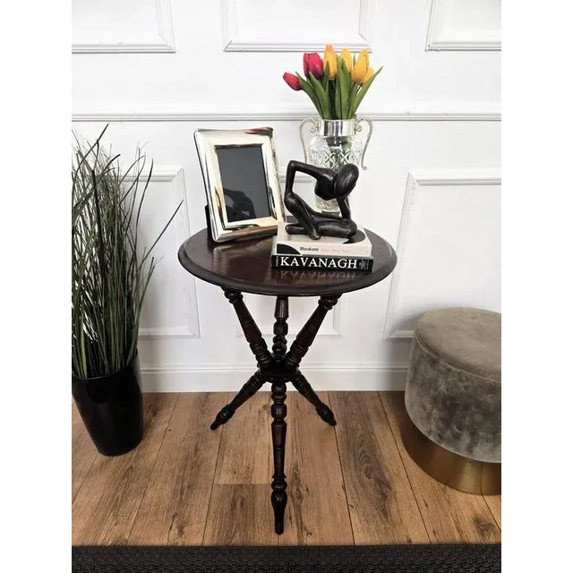 Beautiful antique wooden Italian walnut side table or occasional table with beveled round top raised on three beautifully...