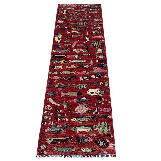 A whimsical pictorial runner in the folk-art fish design, hand-knotted in northern Afghanistan from hand-spun Ghazni wool....