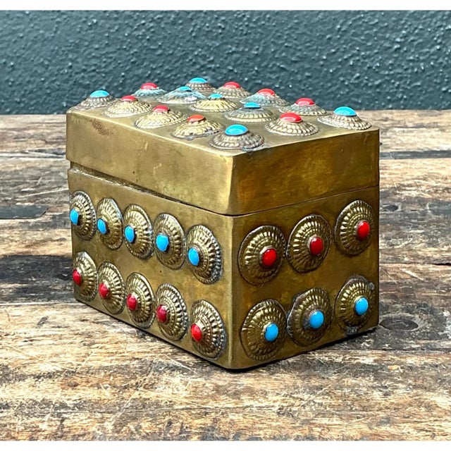 This box makes a bold decorative statement through its dense field of raised, stone-set brass medallions covering every...