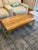 This distinctive West Elm coffee table pairs a beautifully figured natural wood top with an architectural metal base...